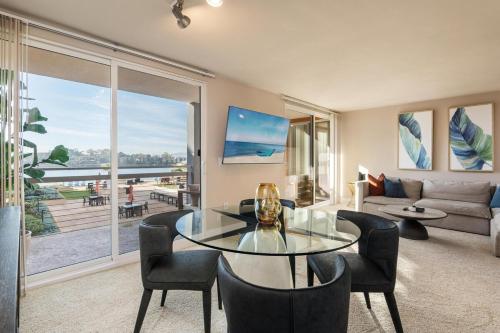 a living room with a glass table and chairs at The Citrine Suite - Water View Large Condo 2BR Marina in Los Angeles
