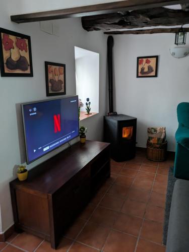a living room with a tv and a fireplace at Casa Rural Sarrion in Teruel