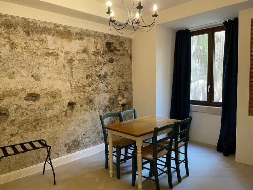 a dining room with a wooden table and chairs at Castello D'Alcontres Guest House 3 stelle in Nizza di Sicilia