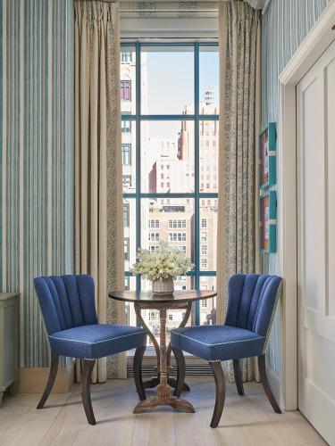 a room with two chairs and a table and a window at Warren Street Hotel in New York