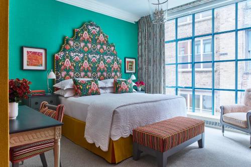 a bedroom with a large bed with a christmas tree at Warren Street Hotel in New York