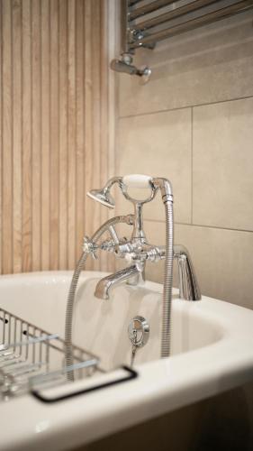 a bathroom sink with a chrome faucet on it at Snowdonia Quarryman cottage in Llanberis