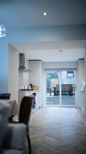 a kitchen and living room with a couch and a table at Snowdonia Quarryman cottage in Llanberis
