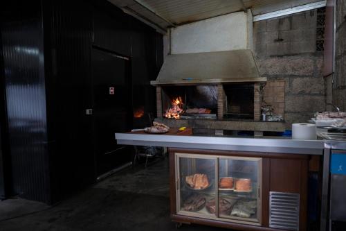 a kitchen with an oven with meat in it at La posada in Porriño