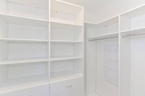 a white walk in closet with white shelves at Harbourtown Suites on Plymouth Harbor in Plymouth