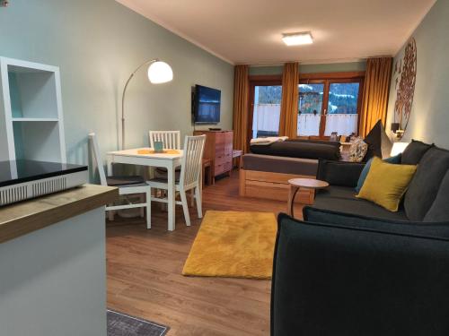 a living room with a couch and a table at Ferienunterkunft Bergluft in Balderschwang