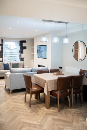 a living room with a table and chairs and a couch at Snowdonia Quarryman cottage in Llanberis