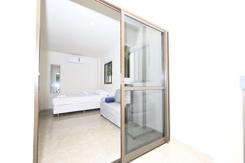 a sliding glass door leading to a living room at Studio Céu Azul, Pontal de Maracaípe PE in Porto De Galinhas