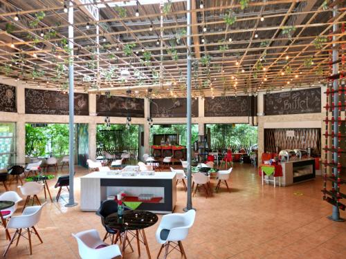 a large room with chairs and tables in a building at Ecopark Hosteria Puyo in Puyo