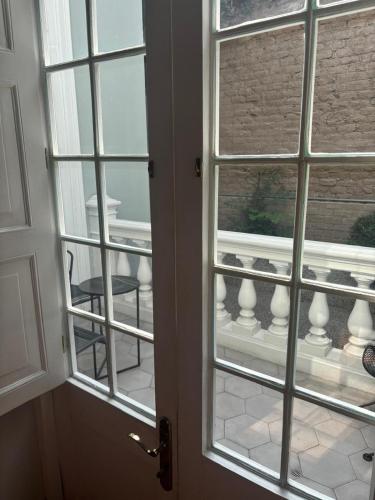 an open door with a view of a balcony at Villa Barranco by Ananay Hotels in Lima