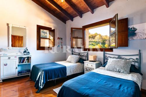 a bedroom with two beds and a sink at Casa la fuente in Vibaño