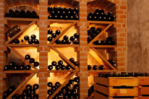 a wall of wine bottles in a wine cellar at Hotel und Residence Johanneshof in Cermes