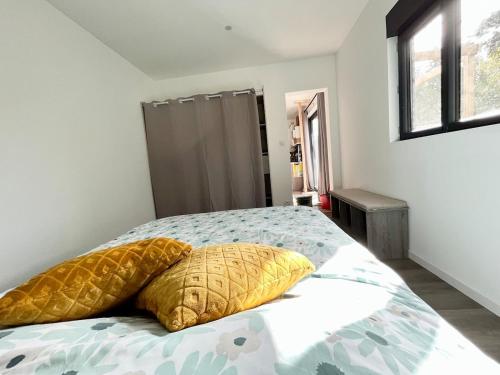 a bedroom with a bed with two pillows on it at L'ATELIER de RUELLE in Ruelle-sur-Touvre
