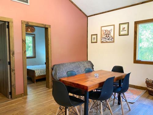 a dining room with a table and chairs at Carpinterito cabaña, ensenada campestre in Puerto Varas