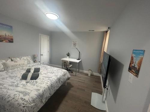 a bedroom with a bed and a television and a desk at Cozy 2-3 Bedroom Apartment in Center City! in Philadelphia