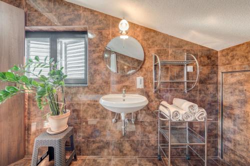 a bathroom with a sink and a mirror at Apartments Deepwater in Slatine