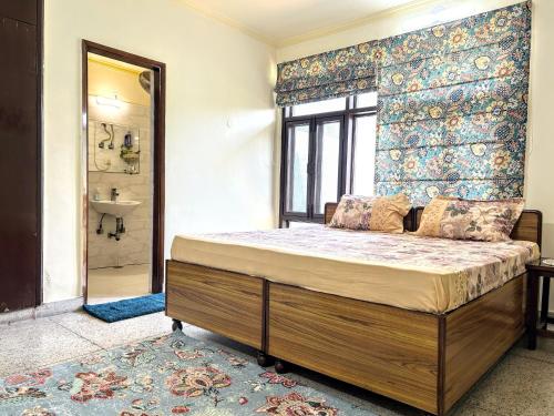 a bedroom with a bed and a sink and a mirror at Pearl of Nature By Nyra in New Delhi