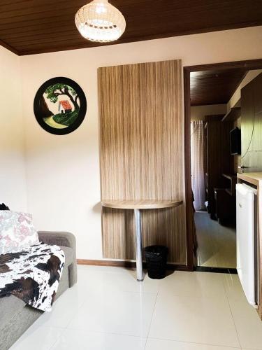 a bedroom with a bed and a clock on the wall at Eco Hotel Bouganville in São José dos Pinhais
