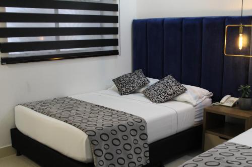 Postel nebo postele na pokoji v ubytování Hotel Merlott Lleras
