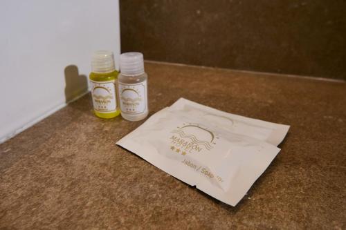 two bottles of honey and a paper bag on a counter at Hotel Marañón in Iquitos