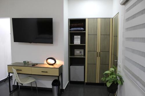 TV a/nebo společenská místnost v ubytování Hotel Merlott Lleras
