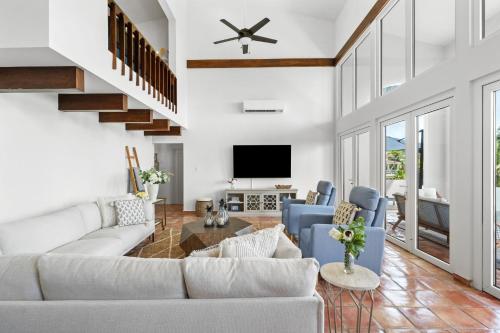 a living room with a couch and chairs and a tv at Olive Villa Palmas - Modern Beachfront in Humacao