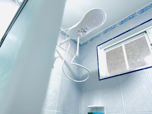 a shower head in a bathroom with a window at Apartamento completo Ideal para descansar en familia en San Salvador in San Salvador