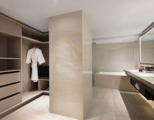 a bathroom with a walk in shower and a sink at Hilton Bali Resort in Nusa Dua