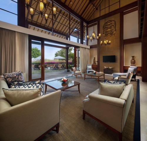 a large living room with couches and a table at Hilton Bali Resort in Nusa Dua