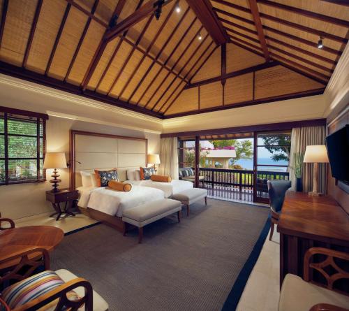 a bedroom with a bed and a living room at Hilton Bali Resort in Nusa Dua