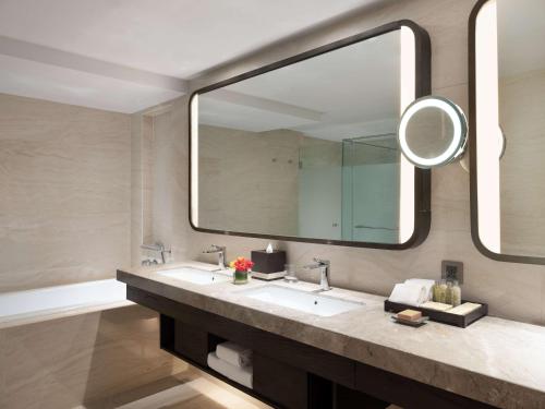 a bathroom with a sink and a large mirror at Hilton Bali Resort in Nusa Dua