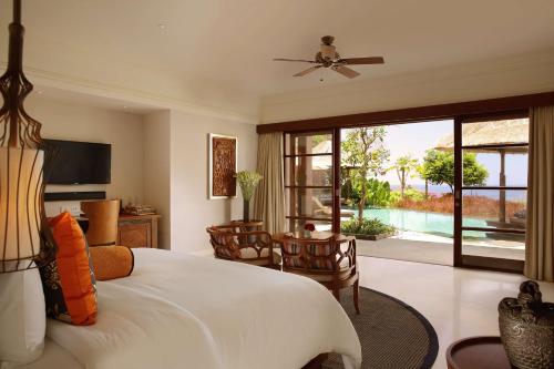 a bedroom with a bed and a view of a pool at Hilton Bali Resort in Nusa Dua