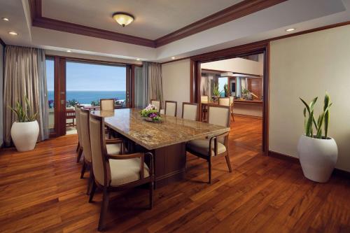 a dining room with a large table and chairs at Hilton Bali Resort in Nusa Dua