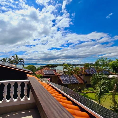 a balcony with solar panels on the roofs of houses at Krone Garten in Florianópolis