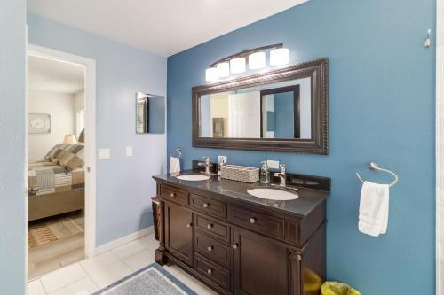 a bathroom with a sink and a mirror at Debany Staycation near Disney in Kissimmee