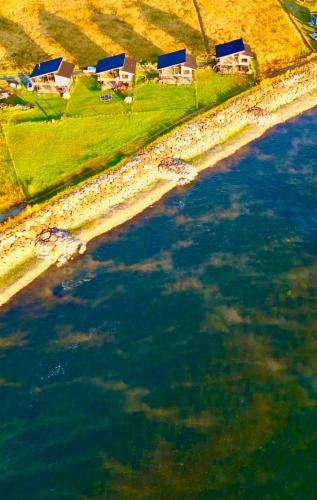 an aerial view of a body of water with houses at Cabañas Leufü Lodge con Tinaja in Valdivia