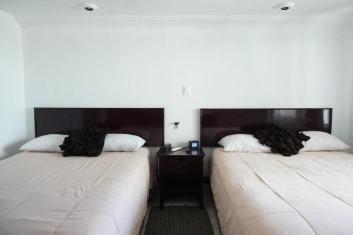 Postel nebo postele na pokoji v ubytování Hotel María Celeste