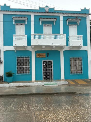 a blue building with white trim and windows at Casa Turbay in Cartagena de Indias