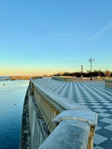 a long walkway over the water near the beach at NOAcH experience in Livorno