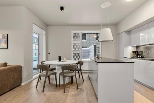 a kitchen and dining room with a table and chairs at City Lux 2BR & 2BA with Free Parking City Center in Reykjavík