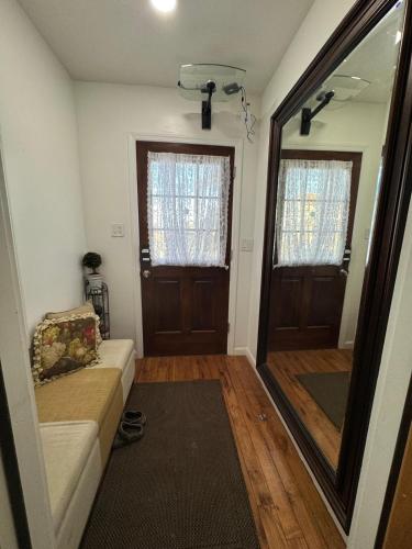 a living room with a couch and a mirror at Dayton Dream in Newark