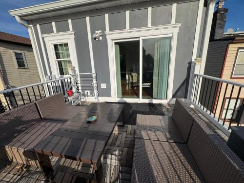 a deck with a table and chairs on a house at Dayton Dream in Newark