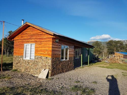 a person taking a picture of a house at Turismo Raíces in Coihaique