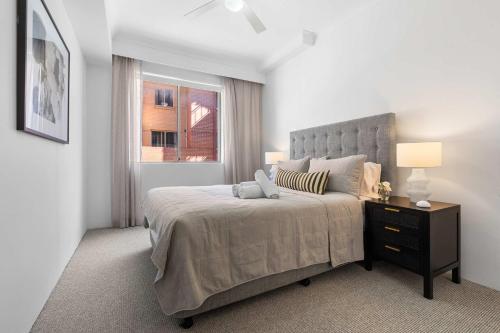 a bedroom with a large bed and a window at Camperdown Cozy Corner 1 in Sydney