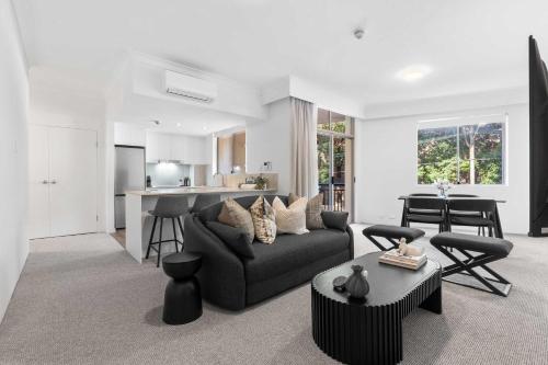 a living room with a couch and a table at Camperdown Cozy Corner 1 in Sydney