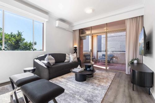 a living room with a couch and a table at Camperdown Cozy Corner 3 in Sydney