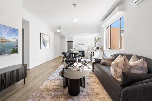 a living room with a couch and a table at Camperdown Cozy Corner 3 in Sydney