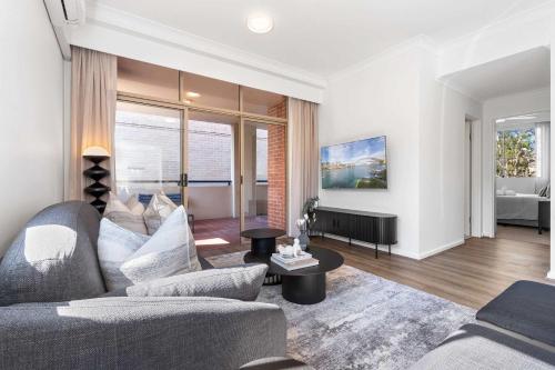 a living room with a couch and a table at Camperdown Cozy Corner 3 in Sydney
