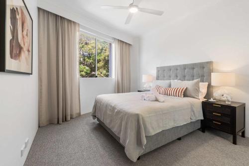a bedroom with a large bed and a window at Camperdown Cozy Corner 3 in Sydney