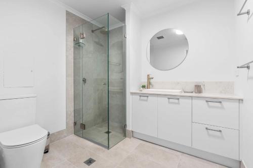 a bathroom with a shower and a toilet and a sink at Camperdown Cozy Corner 4 in Sydney